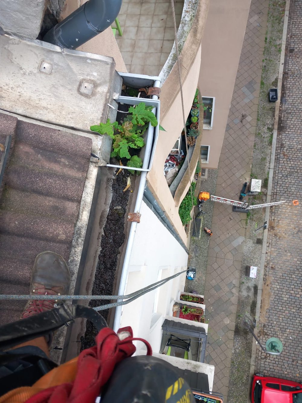 Looking down a rooftop line during gutter access work