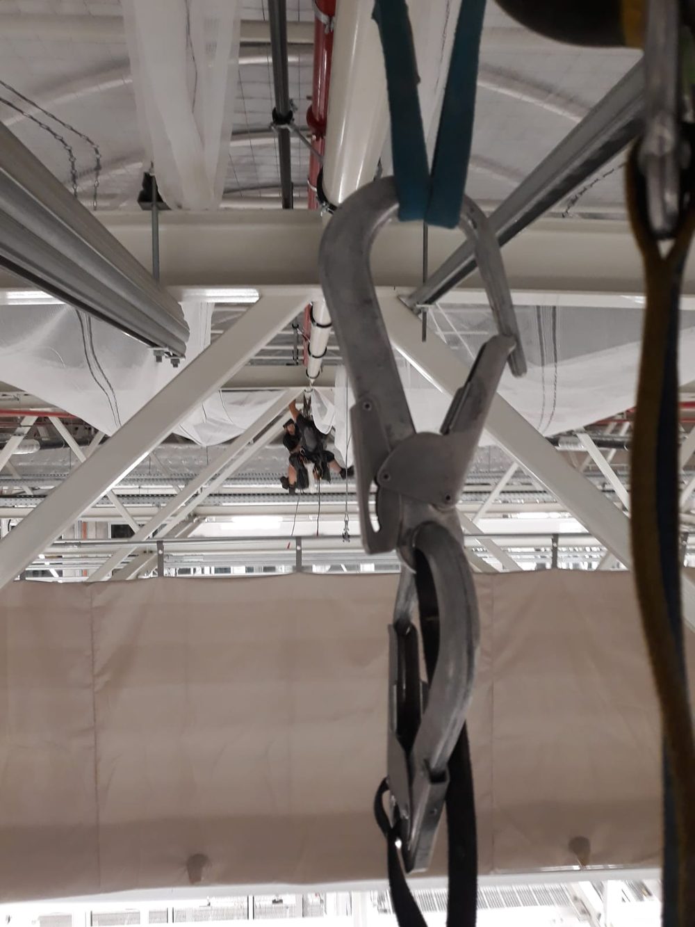 Rigging shackle with a colleague working the truss overhead