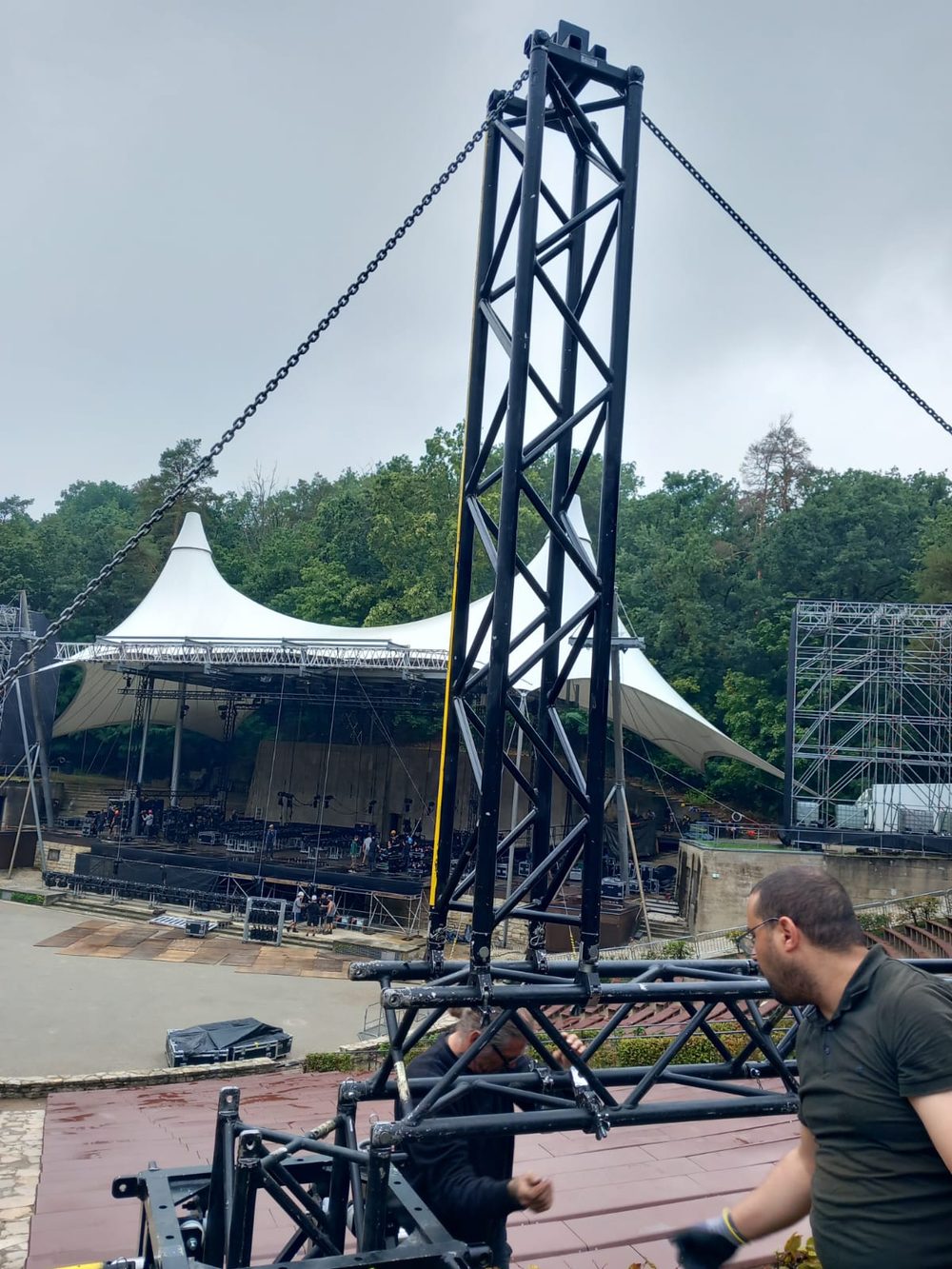 Truss tower being assembled at an outdoor amphitheatre stage